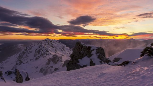 snowy and windy sunset in Navacerrada mountains, Madrid. Lenticular clouds at sunset.