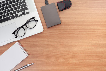 Top view laptop and note on wood table . a businessman using computer ,new work concept