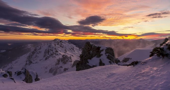 snowy and windy sunset in Navacerrada mountains, Madrid. Lenticular clouds at sunset.