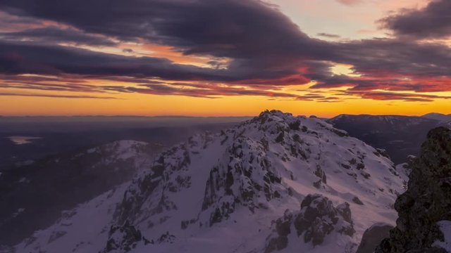 snowy and windy sunset in Navacerrada mountains, Madrid. Lenticular clouds at sunset.