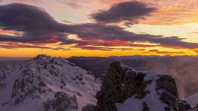 snowy and windy sunset in Navacerrada mountains, Madrid. Lenticular clouds at sunset.