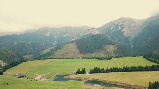 Forward drone shot over a valley next to mountains. 4K video in Slovakia