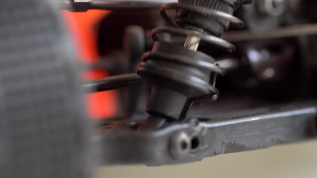 Black spring with a car damper during working macro shot.