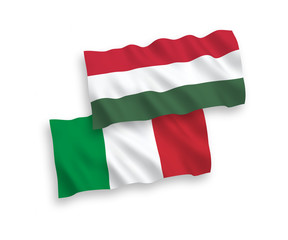 Obraz premium National vector fabric wave flags of Italy and Hungary isolated on white background. 1 to 2 proportion.