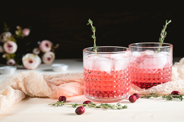 Red Cocktail with herbs on wooden table