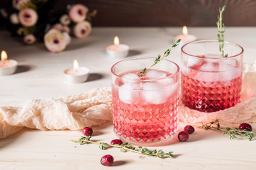 Red Cocktail with herbs on wooden table