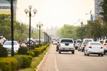 Local traffic during sunset on the busy streets of Vientiane, Laos. Vientiane is the capital and...