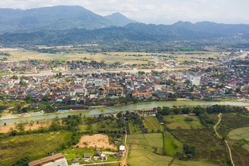 Fototapeta na wymiar View from above, aerial view of the beautiful city of Vang Vieng. Vang Vieng (also Vang Viang) is a tourist-oriented town in Laos in Vientiane Province about four hours bus ride north of the capital.