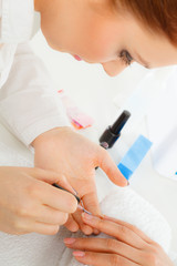 Obraz na płótnie Canvas Woman in beauty salon getting manicure done.