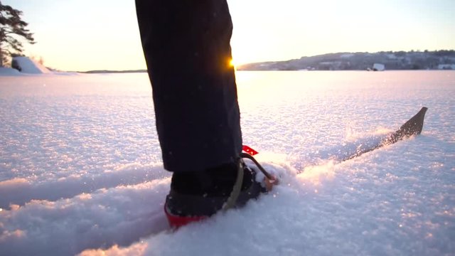 Cross-country Ski on a frozen Swedish lake in the sunset. Filmed with super slow motion and a drone.