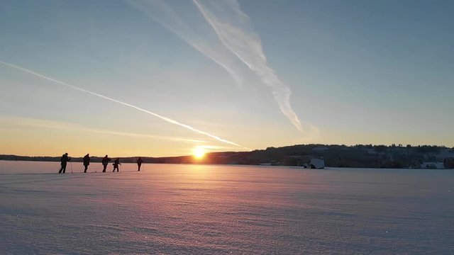 Cross-country Ski on a frozen Swedish lake in the sunset. Filmed with super slow motion and a drone.