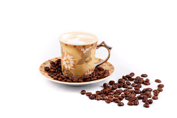 cup of coffee with grains on a white background