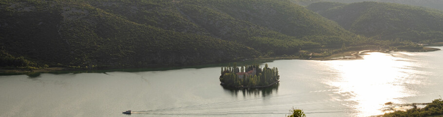 Large panoramic aerial view of Visovac Monastery on the Visovac island at sunset time. Krka National Park, Croatia