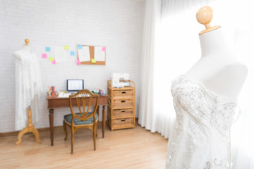 White dress in the studio with the idea to write a note on the wall. Selective focus at mannequin