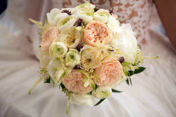 Close up. Bride holding a beautiful wedding bouquet of flowers