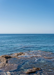 Waves on Rocks and the Clear Turquoise Blue Water at a Southern Mediterranean Beach in Italy