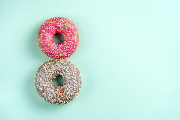 Donuts on blue background, copy space.