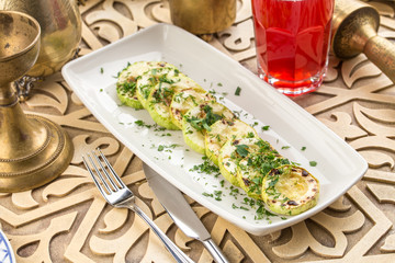 green zucchini grilled with dark stripes on oriental table