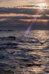 Long Exposure of a Sunset on the Southern Mediterranean Sea in Italy with Ancient Roman Wall