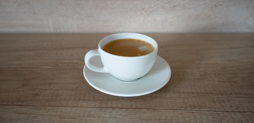 Minimalistic isolated coffee cup on wooden background