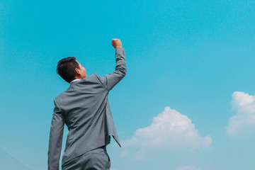 businessman with arms raised sign of success