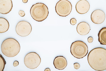 Pine tree cross-sections with annual rings on white background. Lumber piece close-up shot, top...