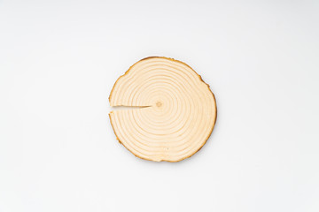 Pine tree cross-section with annual rings on white background. Lumber piece close-up shot, top view, isolated.