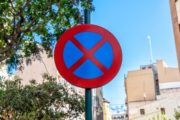 Road sign "no parking" under blue sky