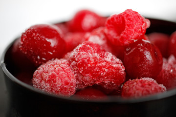 frozen raspberry berries in a black glass berry