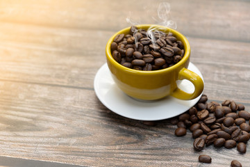 Yellow cup of hot coffee.