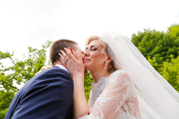 beautiful wedding couple posing outdoor