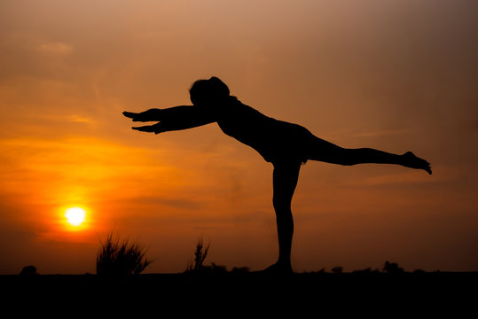 Silhouette Asia woman yoga on sunset. - Image