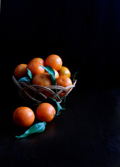 tangerines  in a basket on a black background fruit dessert healthy food