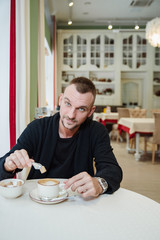 Fototapeta na wymiar man in cafe with cup of coffee