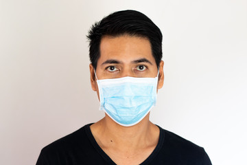 Young Asian man in protective mask