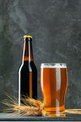 Single beer glass close up on dark stone background