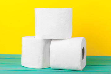 Toilet paper stacks  on bright yellow background