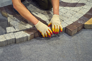 Master puts sidewalk tile.