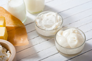homemade dairy product samples on white wood table background