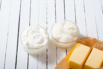 homemade dairy product samples on white wood table background