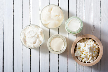 homemade dairy product samples on white wood table background