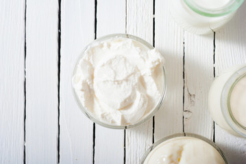 yogurt and creme fraiche on white wooden table background