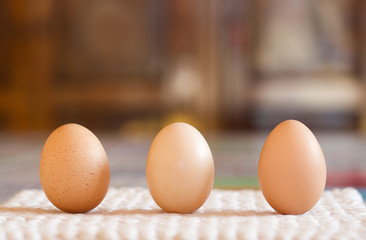 close up of three chichen eggs on the table