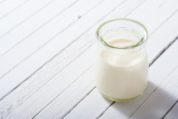 goat milk on white wooden table