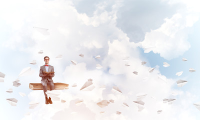 Young businessman or student in blue sky studying the science