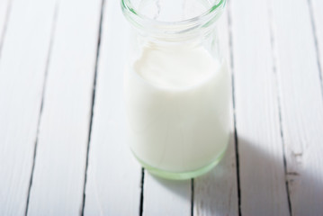 bottle of milk on white wood table