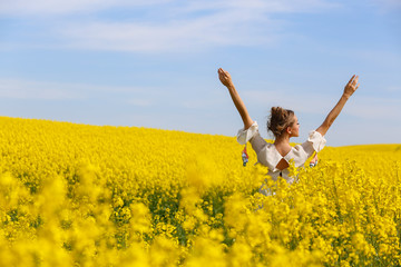Beautiful blonde girl posing in yellow field
