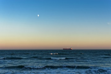 Red Ship on the Horizon at Sunset