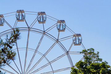 Ferris wheel over blue sky