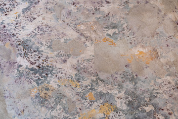 Textured wall abstract background with multiple layers of old paint and patterns - Worn colored layers of paint and stencils revealing patchy surface and cement sand texture
